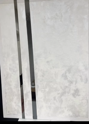 Accent wall design in white silk and black mirror strips