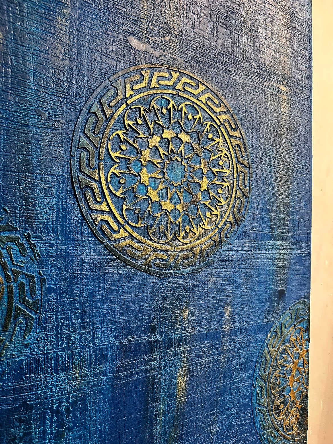 accent wall in royal blue and gold stencils